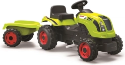 Poganjalni traktor CLAAS z zelenim prikolnikom