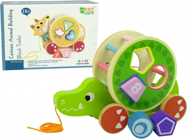 Lesena vlečna igrača krokodil s sortirko