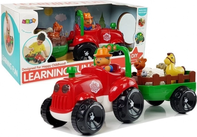 Glasbeni traktor z prikolico in živalmi na baterije