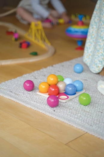 Wooden construction pyramid of colorful marbles