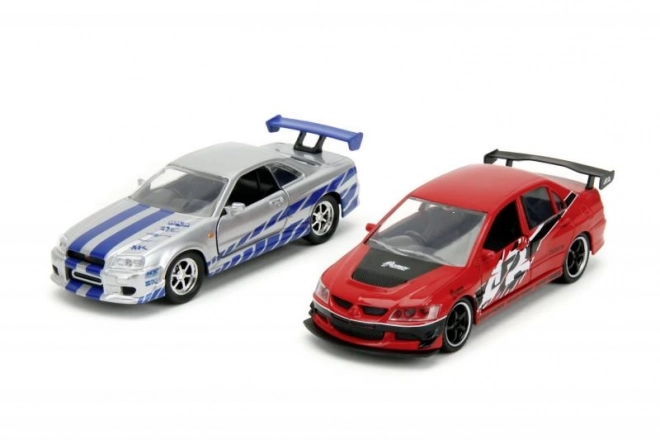 Hitri in drzni Twin Pack 2006 Mitsubishi Lancer Evo IX + Brianov 2002 Nissan Skyline GTR R34, 1:32 Val 4/2