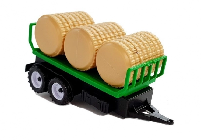 Traktor s prikolico za bale sena Cisterne