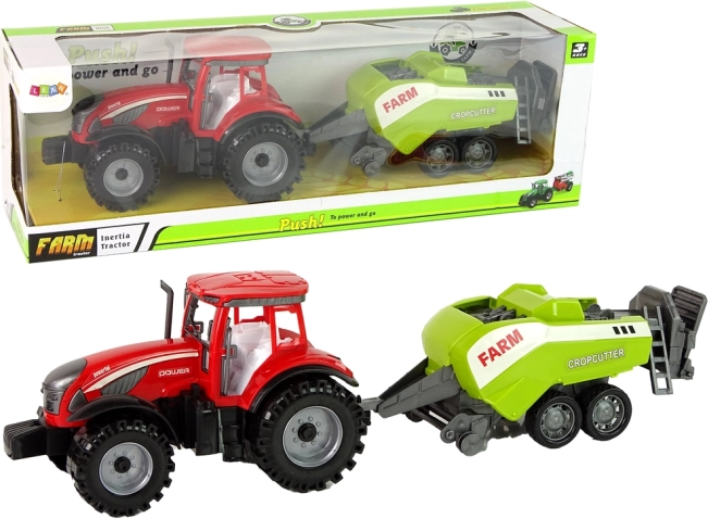 Rdeč traktor z zelenim sejalnikom s frikcijskim pogonom
