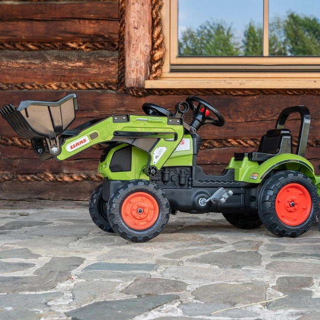 Šlapalni traktor Claas Arion 410 z zeleno prikolico