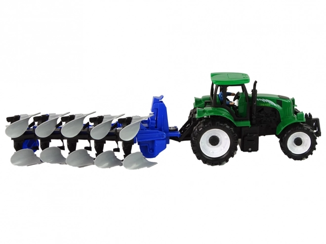 Zeleni kmetijski traktor s plugom