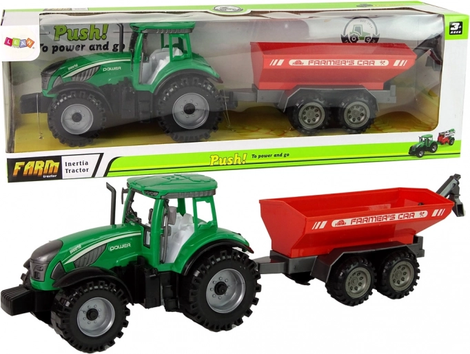 zeleni traktor z rdečo prikolico s vztrajnikom