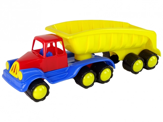 Velik tovornjak z rumeno prikolico dolžine 45 cm