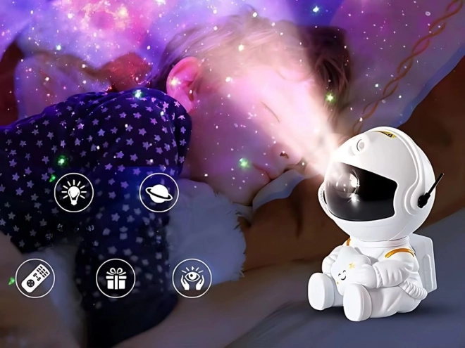 Zvezdni projektor s sedečim astronavtom in daljinskim upravljalnikom