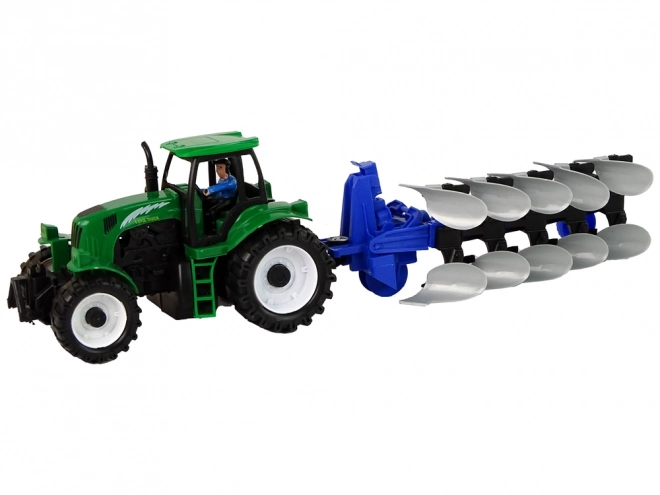 Zeleni kmetijski traktor s plugom