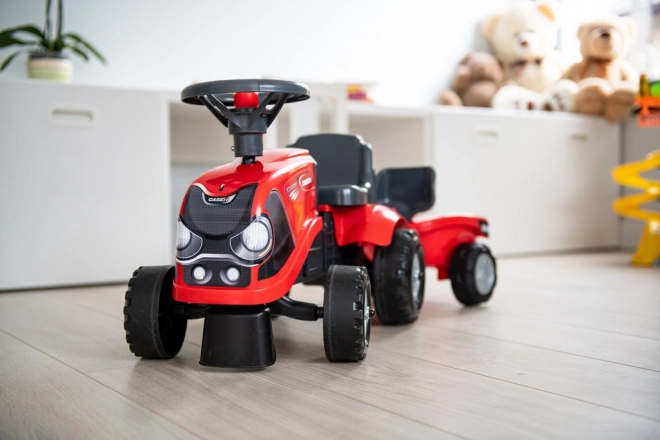 Vozeči traktor Baby Case IH rdeč s prikolico
