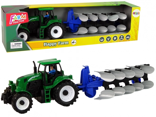 Zeleni kmetijski traktor s plugom