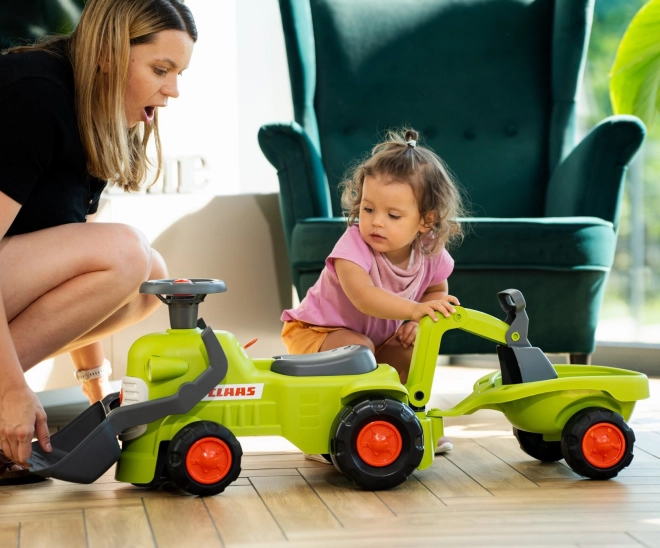 Vozni traktor Claas s prikolico, nakladalnikom in žlico