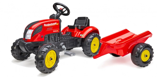 Pedalni traktor z rdečo prikolico