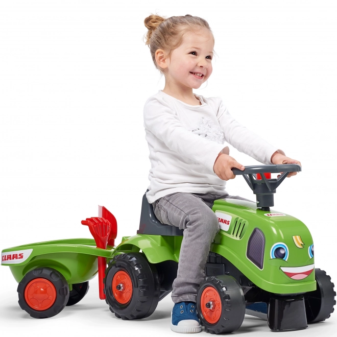 Poganjalec traktor Claas zelen z volanom in prikolico