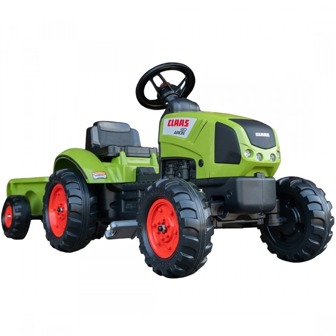 Šlapalni traktor Claas Arion 410 z zeleno prikolico