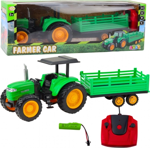 Zeleni daljinsko voden kmetijski traktor s prikolico