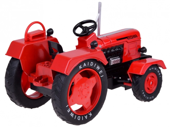 Rdeči kovinski traktor z gumijastimi kolesi 1:18