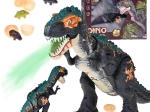 Velik interaktivni dinozaver T‑Rex s paro, lučmi in zvoki, vali jajca